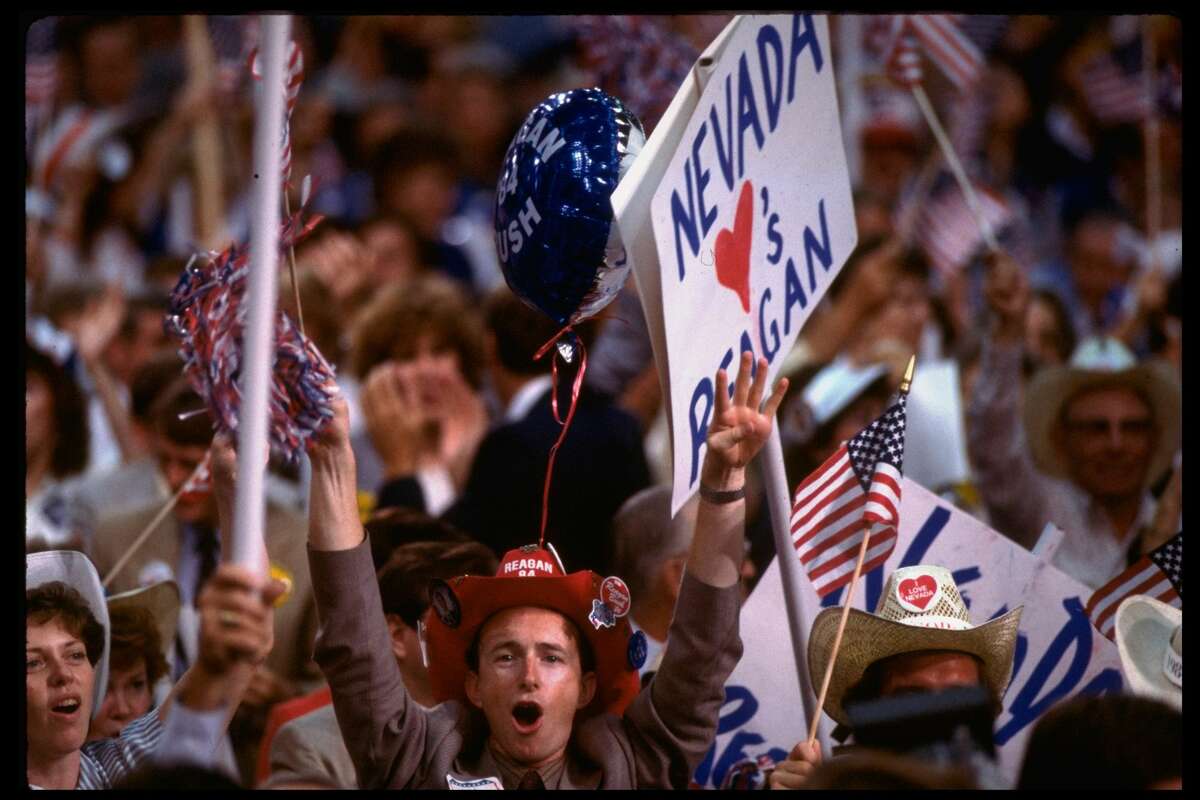 NEVADA LOVES REAGAN sign framing enthused Reagan/Bush supporter with campaign-sloganed cowboy hat, on delegate-crowded Republican National convention floor. (Photo by Bill Pierce/The LIFE Images Collection/Getty Images)