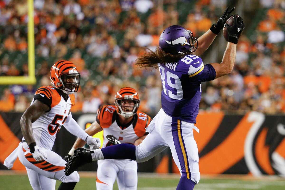 Minnesota Vikings tight end David Morgan (89) makes a catch as Cincinnati Bengals outside linebacker Marquis Flowers, left, and safety Clayton Fejedelem (42) watch during the second half of an NFL preseason football game Friday, Aug. 12, 2016, in Cincinnati. (AP Photo/Gary Landers)