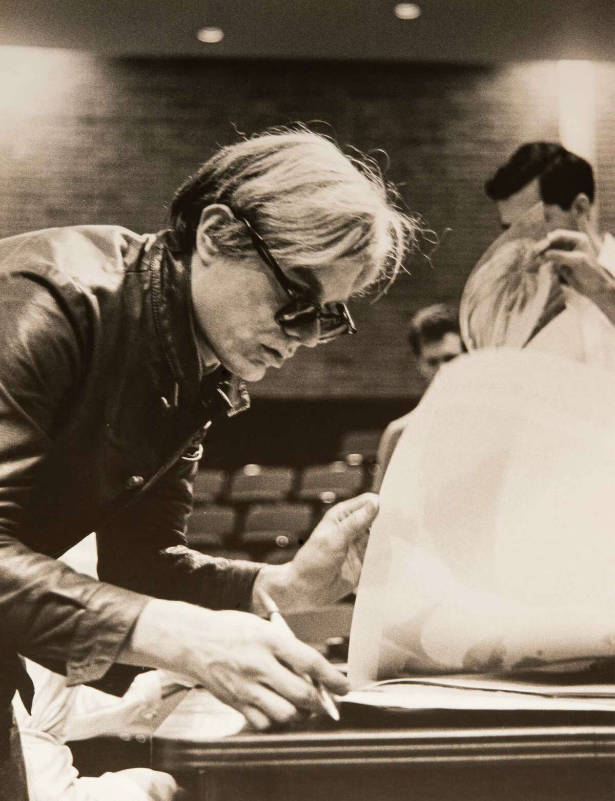 Andy Warhol signing posters, University of St. Thomas, Houston, 1968.
