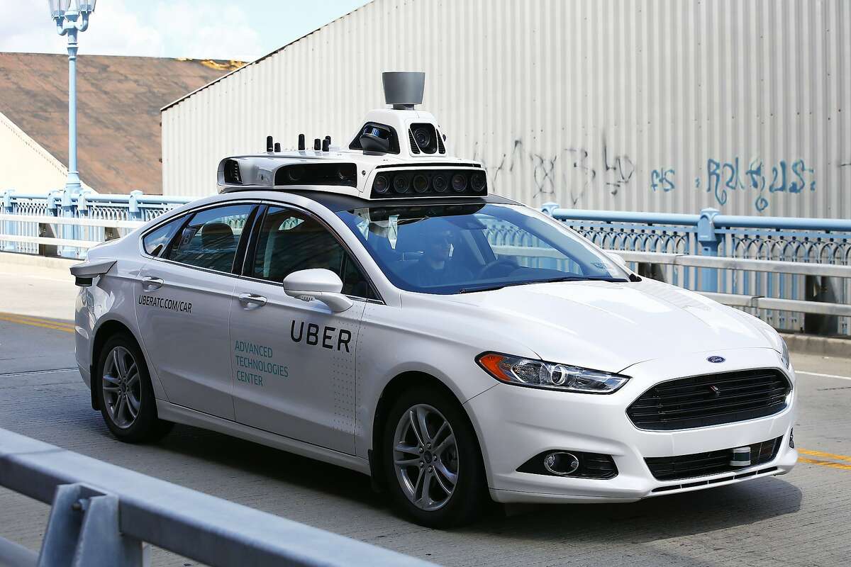 A self-driving Ford Fusion hybrid car is test driven, Thursday, Aug. 18, 2016, in Pittsburgh. Uber said that passengers in Pittsburgh will be able to summon rides in self-driving cars with the touch of a smartphone button in the next several weeks. The high-tech ride-hailing company said that an unspecified number of autonomous Ford Fusions with human backup drivers will pick up passengers just like normal Uber vehicles. Riders will be able to opt in if they want a self-driving car, and rides will be free to those willing to do it, spokesman Matt Kallman said. (AP Photo/Jared Wickerham)
