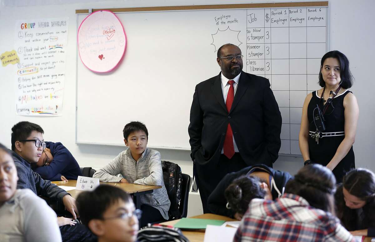 Principal Michael Essien (center) and Assistant Principal Dinora Castro listen as teacher Jennifer Founds describes an activity to her class at Martin Luther King Jr. Academic Middle School in San Francisco, California, on Monday, August 15, 2016.