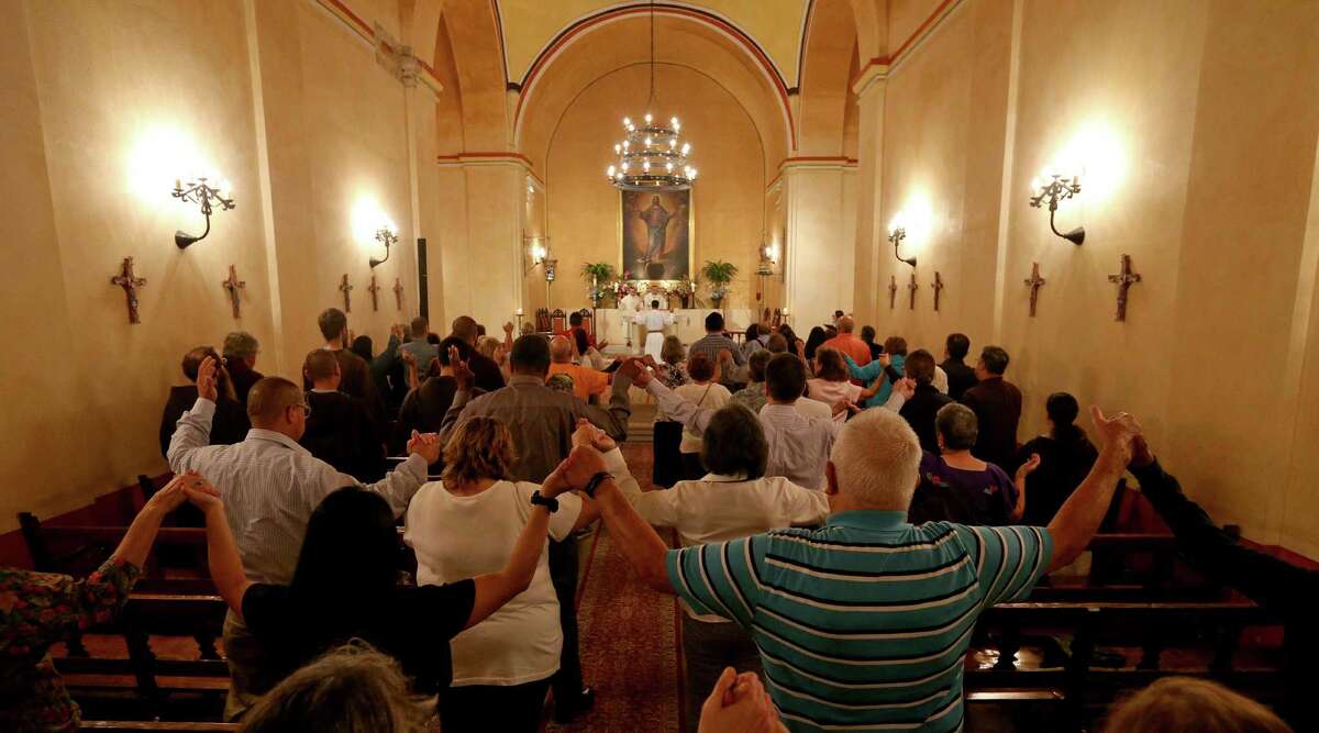 Congregants mark the Feast of the Assumption of the Blessed Virgin Mary at the church at Mission Concepcion in August.
