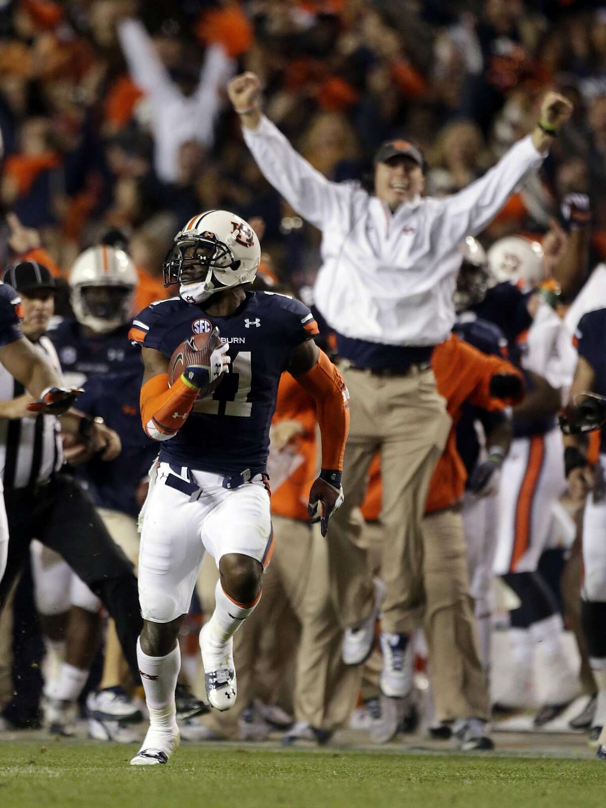 Auburn cornerback Chris Davis (11) returns a missed field goal attempt 100-plus yards to score the game-winning touchdown as time expired in the fourth quarter of an NCAA college football game against No. 1 Alabama in Auburn, Ala., Saturday, Nov. 30, 2013. Auburn won 34-28. (AP Photo/Dave Martin)