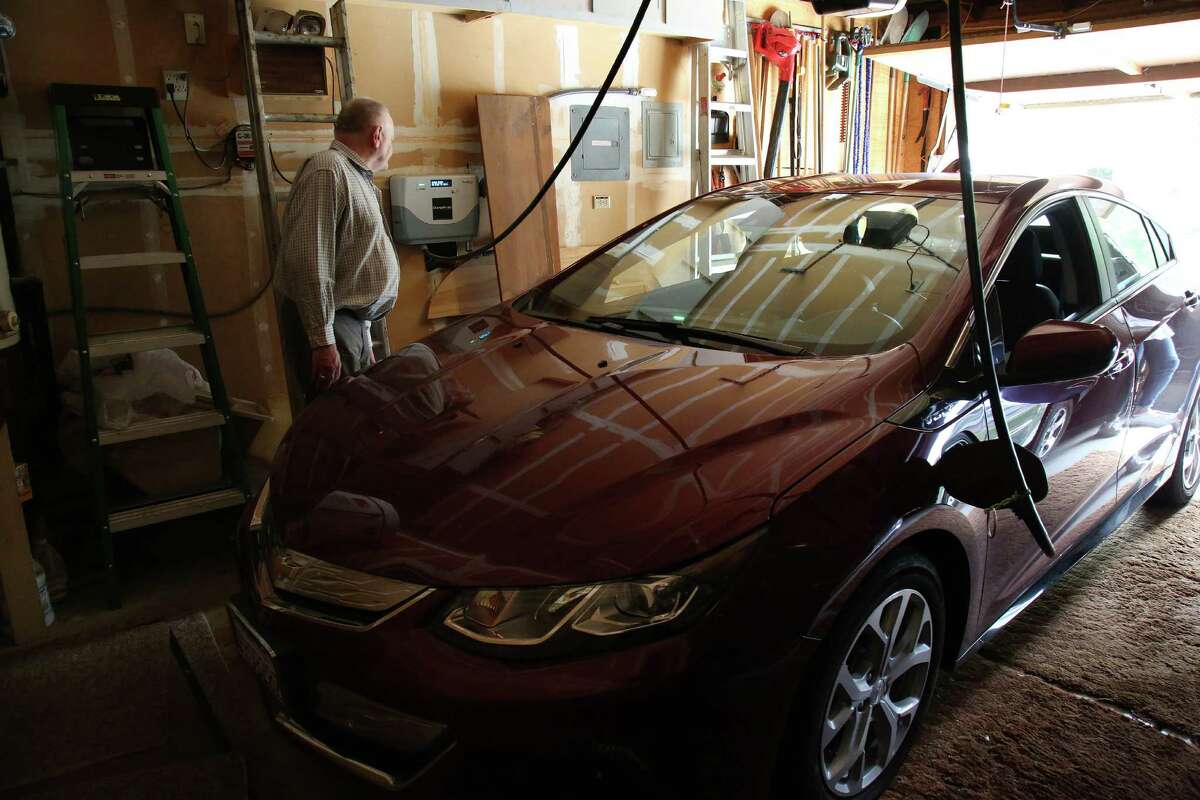 Elroy Holtmann, a retired engineer, charges his Chevy Volt with energy from rooftop solar panels, at home in Lafayette, Calif. There is now so much solar energy coming into California’s grid in the afternoons that peak demand comes closer to evening, as the sun goes down, driving Pacific Gas & Electric to compensate by shifting rates. “They’ve taken any possibility for payback away,” said Holtmann, who spent $20,000 on panels.
