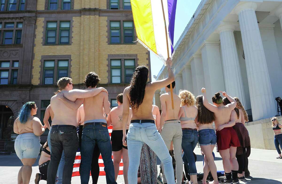 Sage students, upset by police treatment of Cedar Brock, who identifies as androgynous, hold a topless protest in Sage Park on the Russell Sage College campus Wednesday, April 120, 2016 in Troy, N.Y. A school security officer approached Cedar, who was sunbathing topless in a public park that fronts the campus. (Lori Van Buren / Times Union)