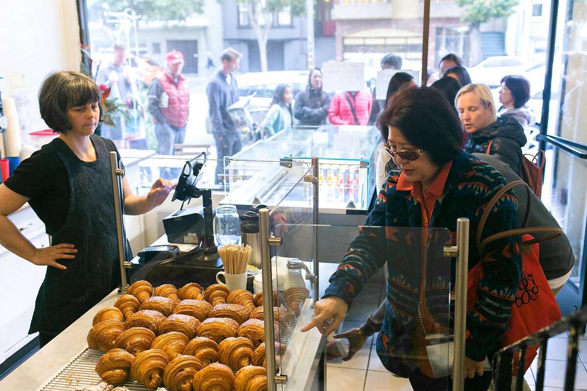 A customer orders a croissant at Arsicault Bakery in S.F.