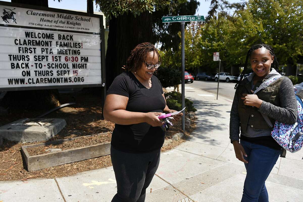 Robin Frazier talks with her daughter Nasrani Fanny while picking her up after her first day of sixth grade at Claremont Middle School in Oakland, CA Monday, August 22, 2016.