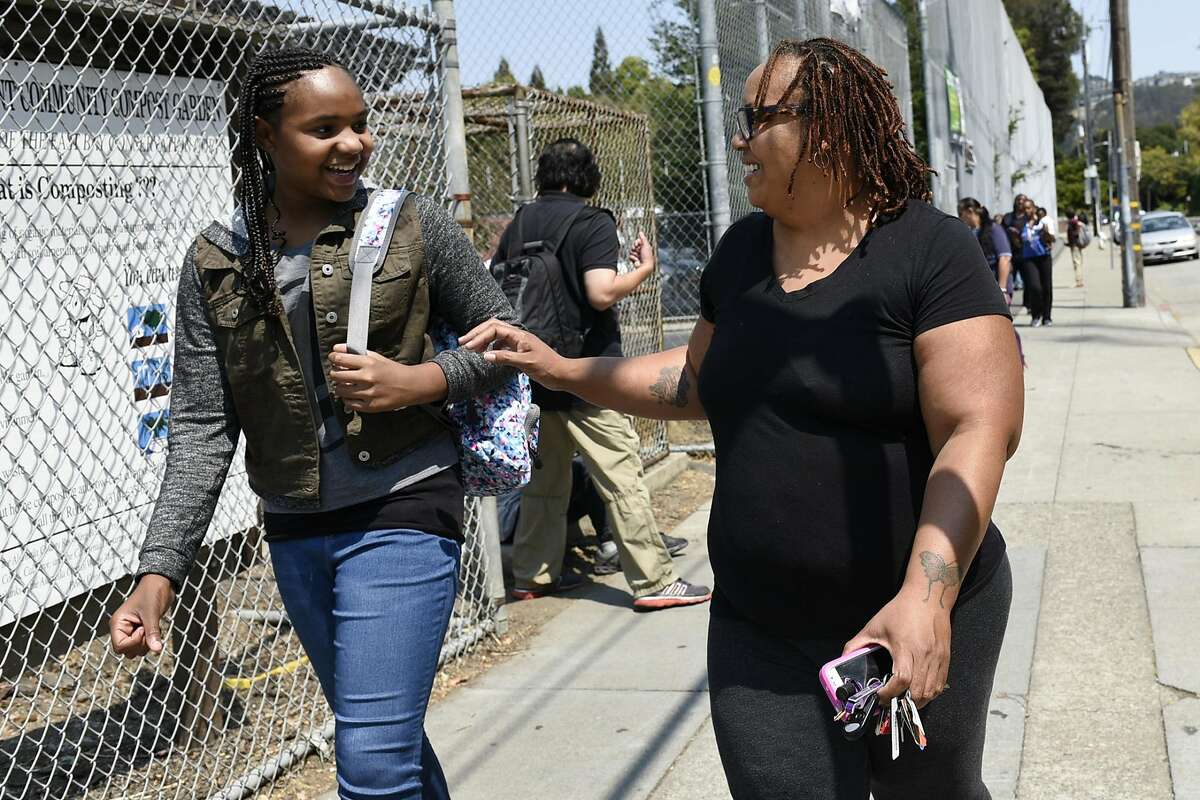 Robin Frazier talks with her daughter Nasrani Fanny while picking her up after her first day of sixth grade at Claremont Middle School in Oakland, CA Monday, August 22, 2016.