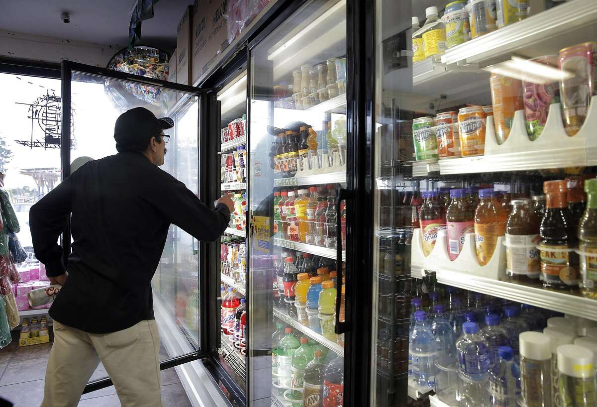 Francisco Serrano looks for a soda at US Liquor Beer & Wine store in Berkeley, Calif., on Monday, August 22, 2016. A new UC-Berkeley study shows that Berkeley's first-of-its-kind-in-the-nation tax on sodas and other sugary drinks has led to a drop in soda consumption in the city's most low-income neighborhoods.