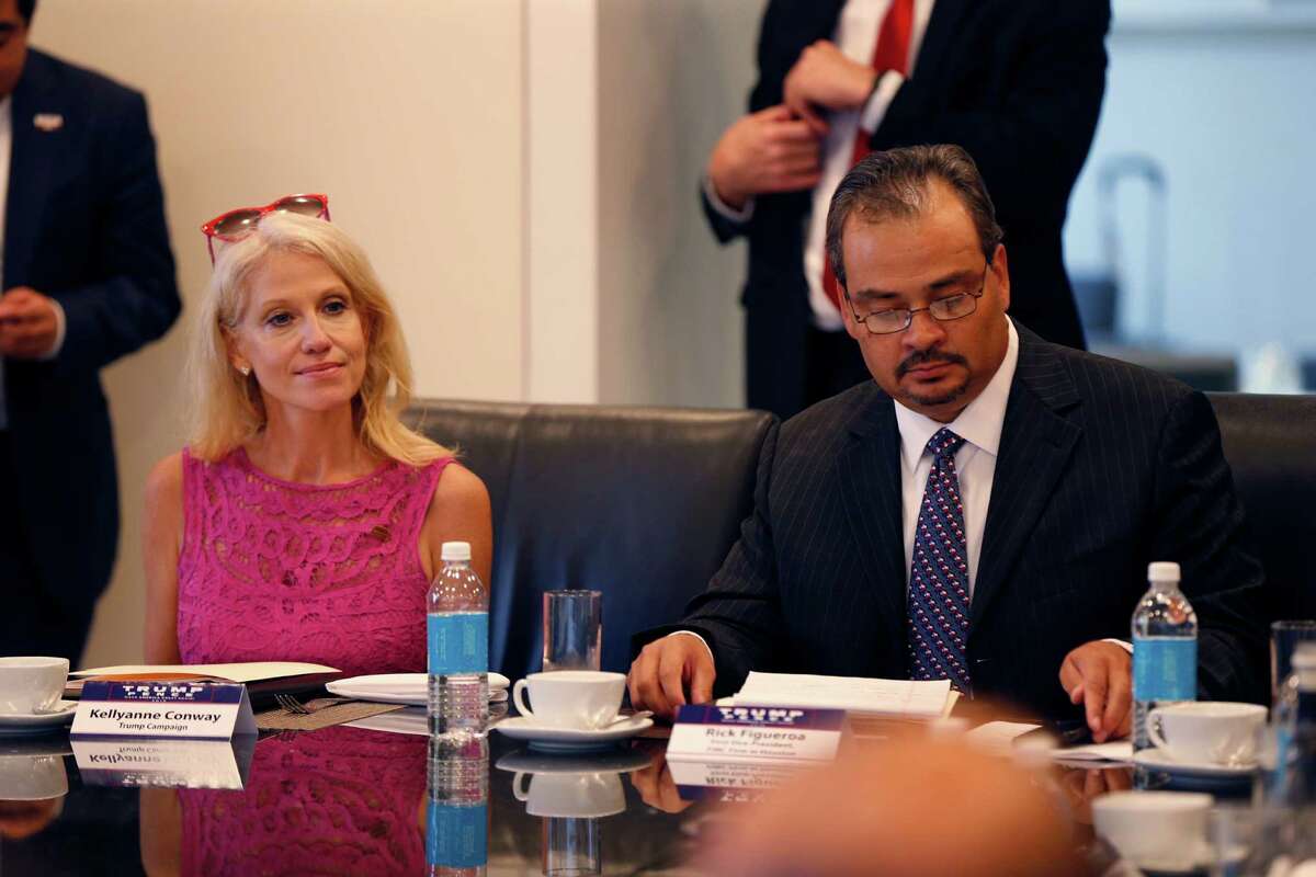 Kellyanne Conway, left, campaign manager for Republican presidential candidate Donald Trump, attends his Hispanic advisory roundtable meeting in New York, Saturday, Aug. 20, 2016. A right is Rick Figueroa, first vice president for FINC Firm of Houston. (AP Photo/Gerald Herbert)