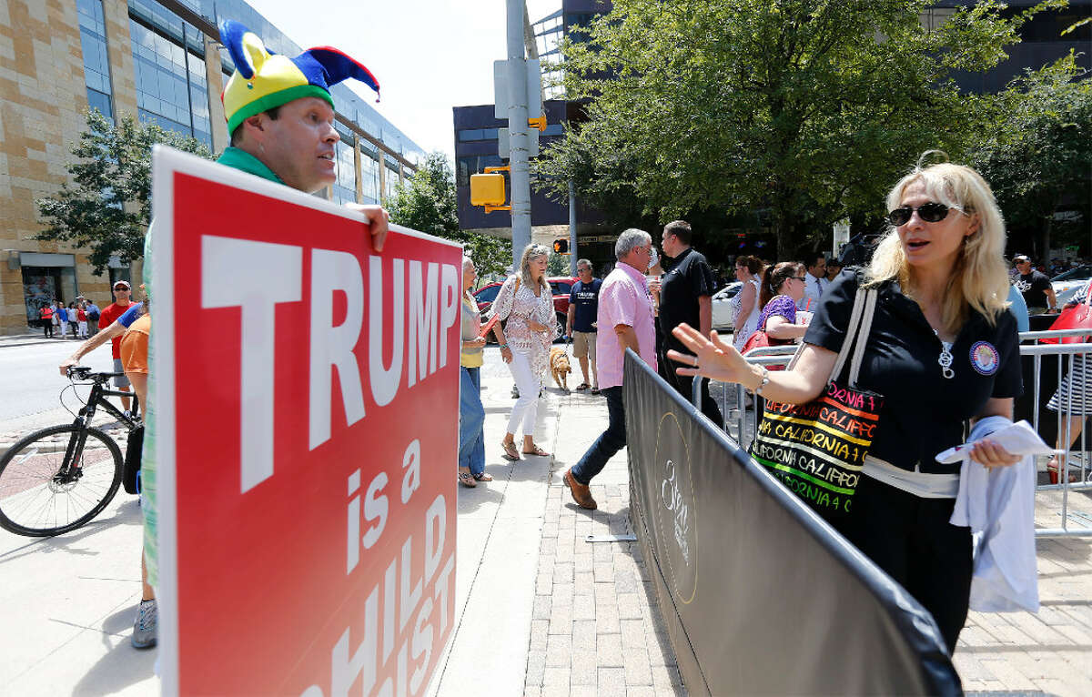 Robert Morrow, Chairman of the Travis County Republican Party (left) exchanges words with a woman entering the Moody Theater for a taping of a town hall with Republican Presidential candidate Donald Trump and Fox News in Austin on Tuesday, Aug. 23, 2016.  Demonstrators from the Texas Democratic Party along with other individuals chanted at Trump supporters as they filed their way into the theater. Along with the town hall meeting, Trump made an appearance for a fundraiser and rally in the Austin area.