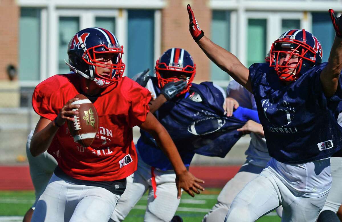 Brien McMahon High School quarterback Chris Druin runs a play during a practice at the Norwalk school Tuesday.