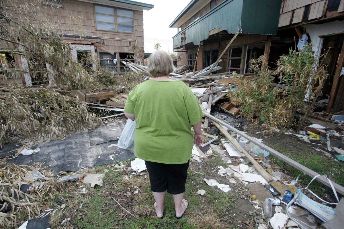 A Galveston resident looks over her wreck apartment complex after Hurricane Ike. TWIA says rates did not need to be raised.