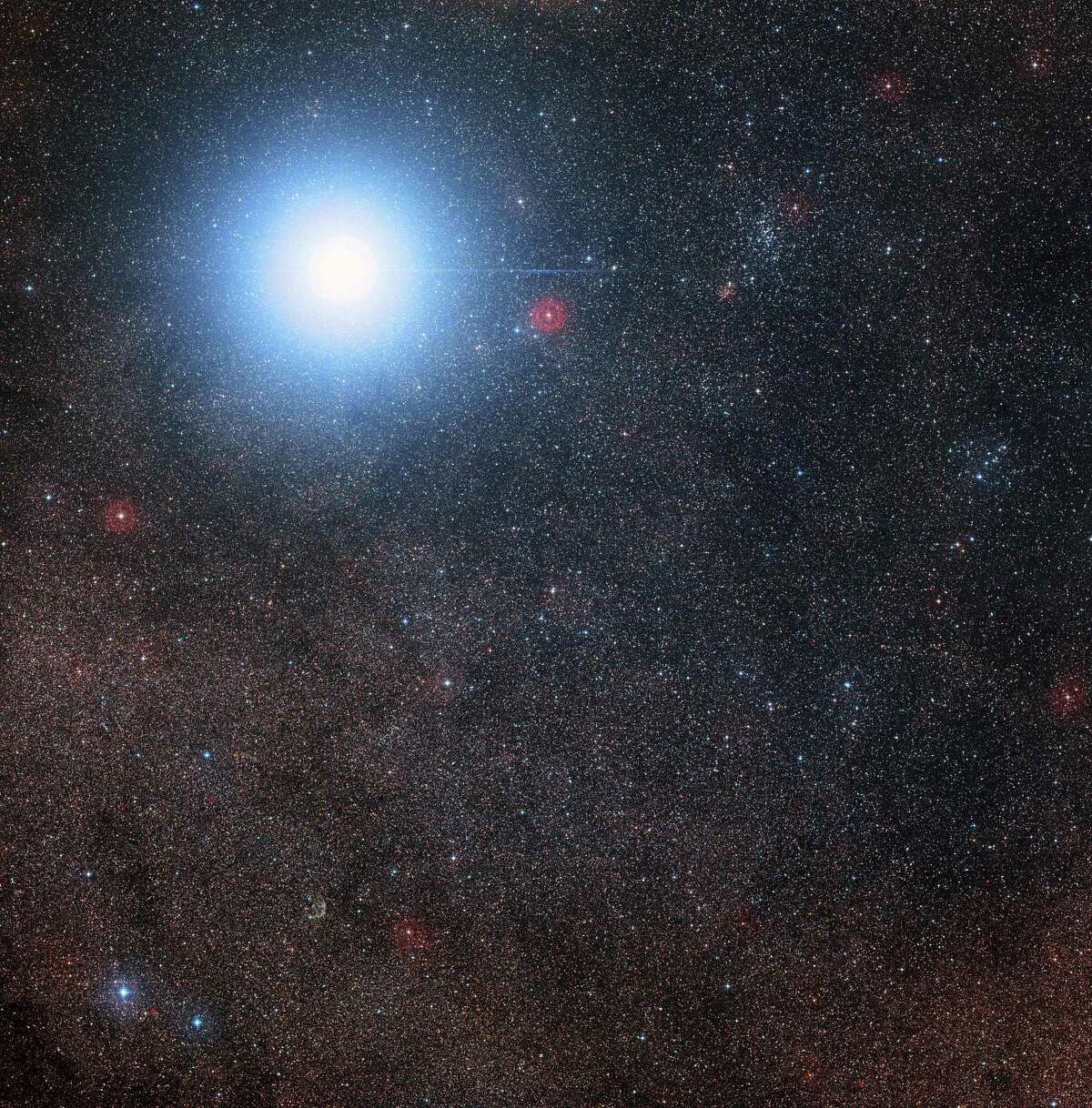 A hand out image made available by the European Southern Observatory on August 24 2016 show an image created from pictures forming part of the Digitized Sky Survey 2 of the sky around the bright star Alpha Centauri AB also shows the much fainter red dwarf star, Proxima Centauri, the closest star to the Solar System. The blue halo around Alpha Centauri AB is an artifact of the photographic process, the star is really pale yellow in colour like the Sun. Scientists on August 24, 2016 announced the discovery of an Earth-sized planet orbiting the star nearest our Sun, opening up the glittering prospect of a habitable world that may one day be explored by robots. Named Proxima b, the planet is in a "temperate" zone compatible with the presence of liquid water -- a key ingredient for life. / AFP PHOTO / EUROPEAN SOUTHERN OBSERVATORY / Davide De Martin/Mahdi Zamani / RESTRICTED TO EDITORIAL USE - MANDATORY CREDIT "AFP PHOTO / EUROPEAN SOUTHERN OBSERVATORY/ DAVIDE DE MARTIN MAHDI ZAMANI- NO MARKETING NO ADVERTISING CAMPAIGNS - DISTRIBUTED AS A SERVICE TO CLIENTS DAVIDE DE MARTIN/MAHDI ZAMANI/AFP/Getty Images