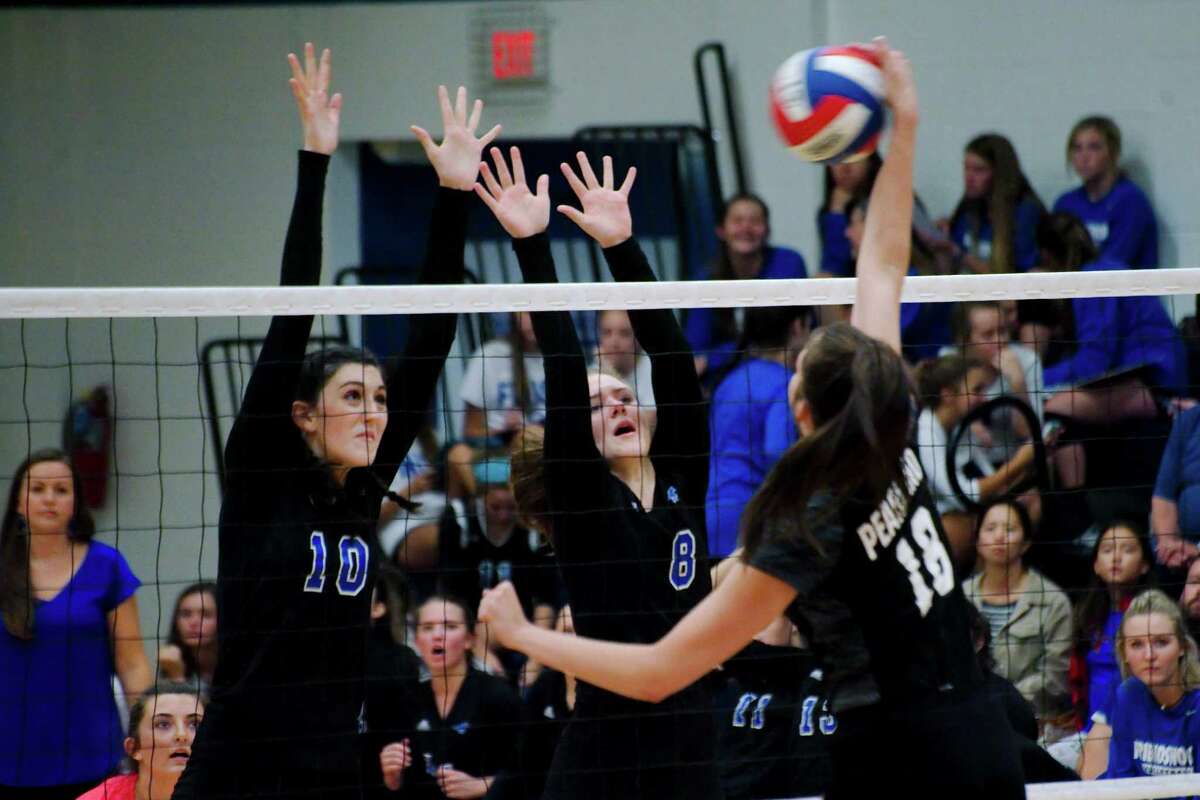 Friendswood's McKenna Fridye (10) and Friendswood's Jenna Chenette (8) go high to block a shot from Pearland's Sam Costello (18) Tuesday, Aug. 23.