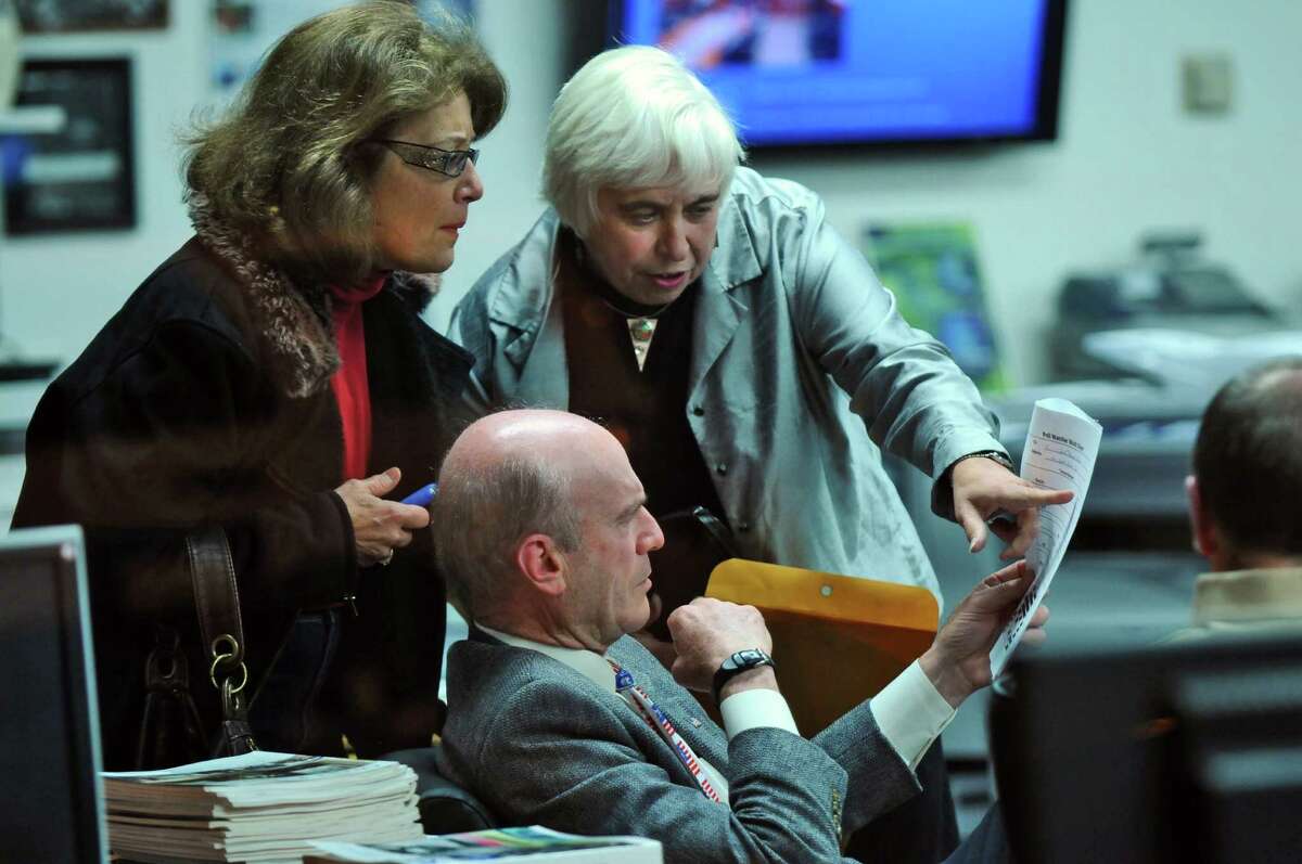 Schenectady Mayoral candidate Roger Hull goes over election returns from the Stockade district with volunteers Mary Ellen Brockbank, left, and Cathy Lewis, right, on Tuesday night Nov. 8, 2011 in Schenectady, NY. (Philip Kamrass / Times Union )