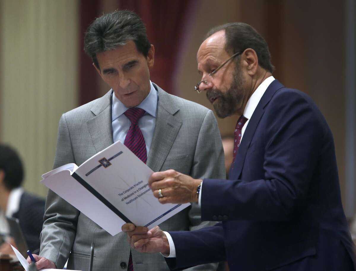State Sen. Mark Leno studies a document with Sen. Jerry Hill at the State Capitol in Sacramento, Calif. on Aug. 25, 2016. It's a busy time of year in the halls of the State Capitol as both the Senate and Assembly wrap up their sessions.