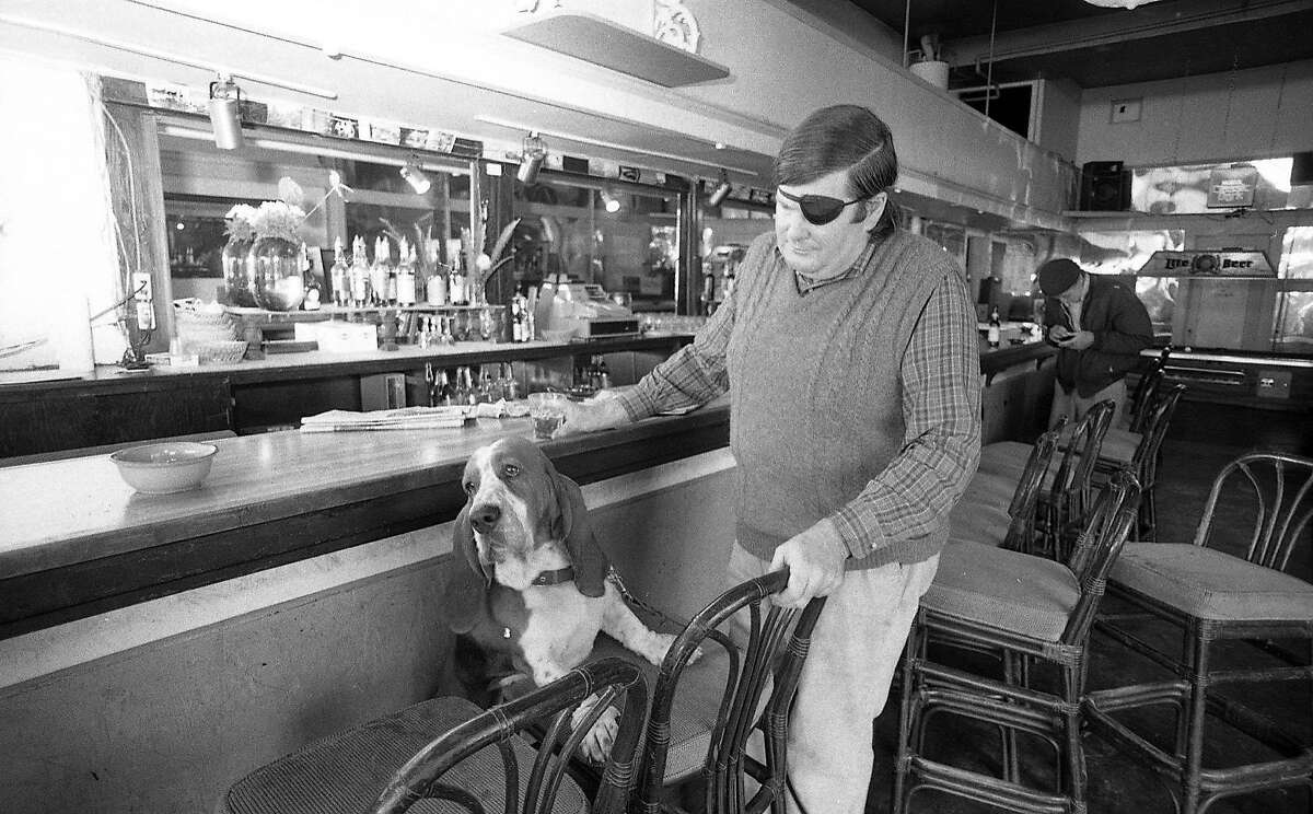 Warren Hinckle, and his Basset dog Bentley at the Pipeline bar Photo taken October 5, 1984