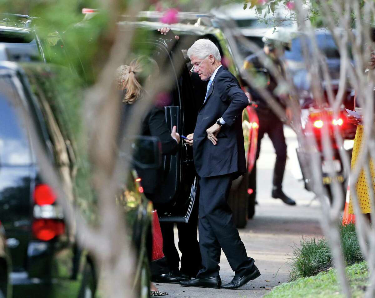 Former president Bill Clinton returns to his car to get something he had forgotten upon entering as he visits the home of Henry Munoz III in San Antonio for a private fundraiser benefiting his wife Hillary Clinton on August 25, 2016