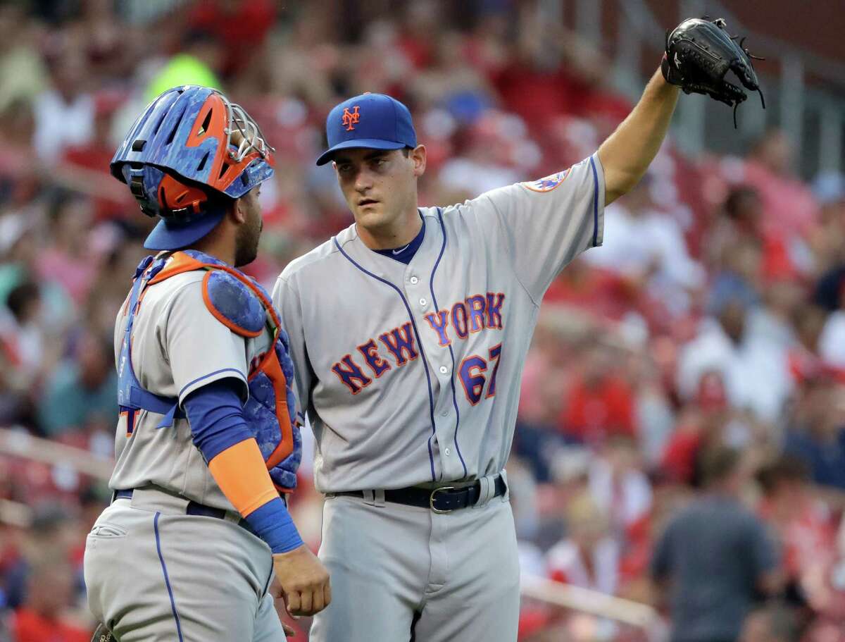 New York Mets starting pitcher Seth Lugo, right, talks with catcher Rene Rivera during the second inning of a baseball game against the St. Louis Cardinals on Thursday, Aug. 25, 2016, in St. Louis. (AP Photo/Jeff Roberson) ORG XMIT: MOJR105
