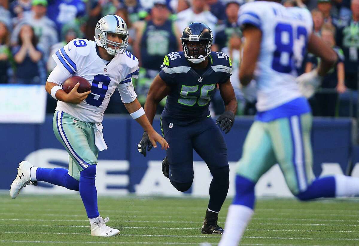 Dallas quarterback Tony Romo (9) runs the ball just before he is sacked by Cliff Avril (56) and sustains a back injury that took him out of the game during Dallas' first possession of the pre-season game between the Seahawks and the Dallas Cowboys, Thursday, Aug. 25, 2016 at CenturyLink Field. Seattle won 27-17.