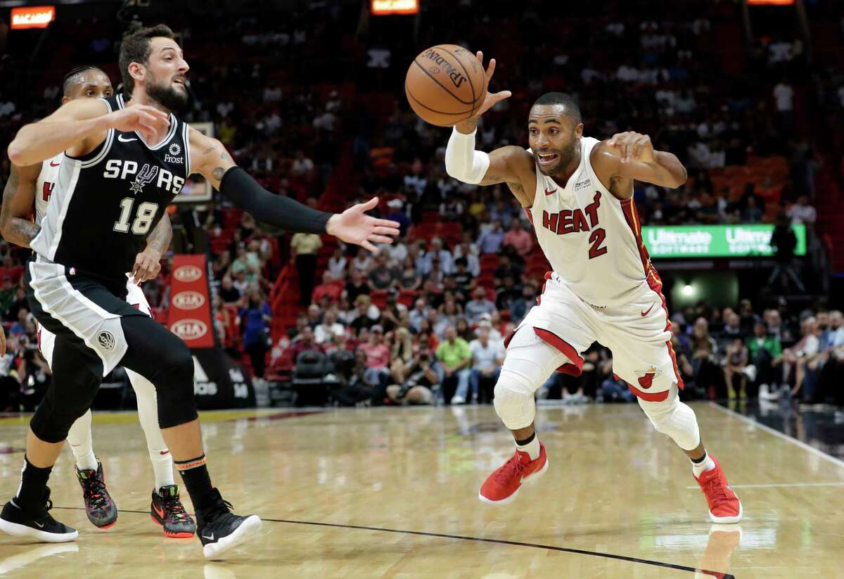 Miami Heat guard Wayne Ellington (2) loses control of the ball as San Antonio Spurs guard Marco Belinelli (18) defends during the first half of an NBA basketball game, Wednesday, Nov. 7, 2018, in Miami. (AP Photo/Lynne Sladky)