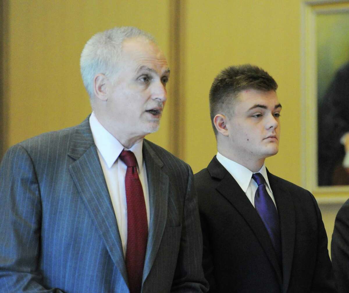 Attorney Eugene Riccio, left, speaks on behalf on Andrew Schmidt, 17, of Greenwich, right, as Schmidt was in Connecticut Superior Court in Stamford, Conn., Friday, Aug., 26, 2016 for a proceeding in front of Judge Gary White to determine if Schmidt is going to be tried as an adult in the hit and run death of Cos Cob resident Edward Setterberg, 43, on the night of April 17.