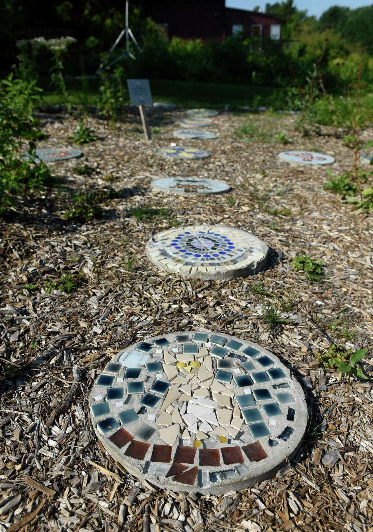 Stepping stones created by students at Carmel Academy line the sensory garden of the Nature Play Trail at the Audubon Greenwich in Greenwich, Conn. Wednesday, Aug. 24, 2016. Carmel art students created colorful, nature-themed mosaics on the stepping stones for the sensory garden.