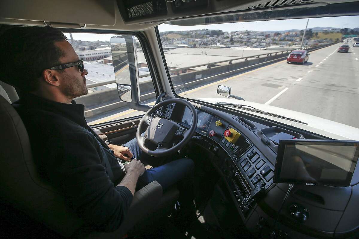Matt Grigsby, senior program engineer at Otto, takes his hands off the steering wheel of the self-driving, big-rig truck during a demonstration on the highway, Thursday, Aug. 18, 2016, in San Francisco. Uber announced that it is acquiring self-driving startup Otto, which has developed technology allowing big rigs to drive themselves. (AP Photo/Tony Avelar)