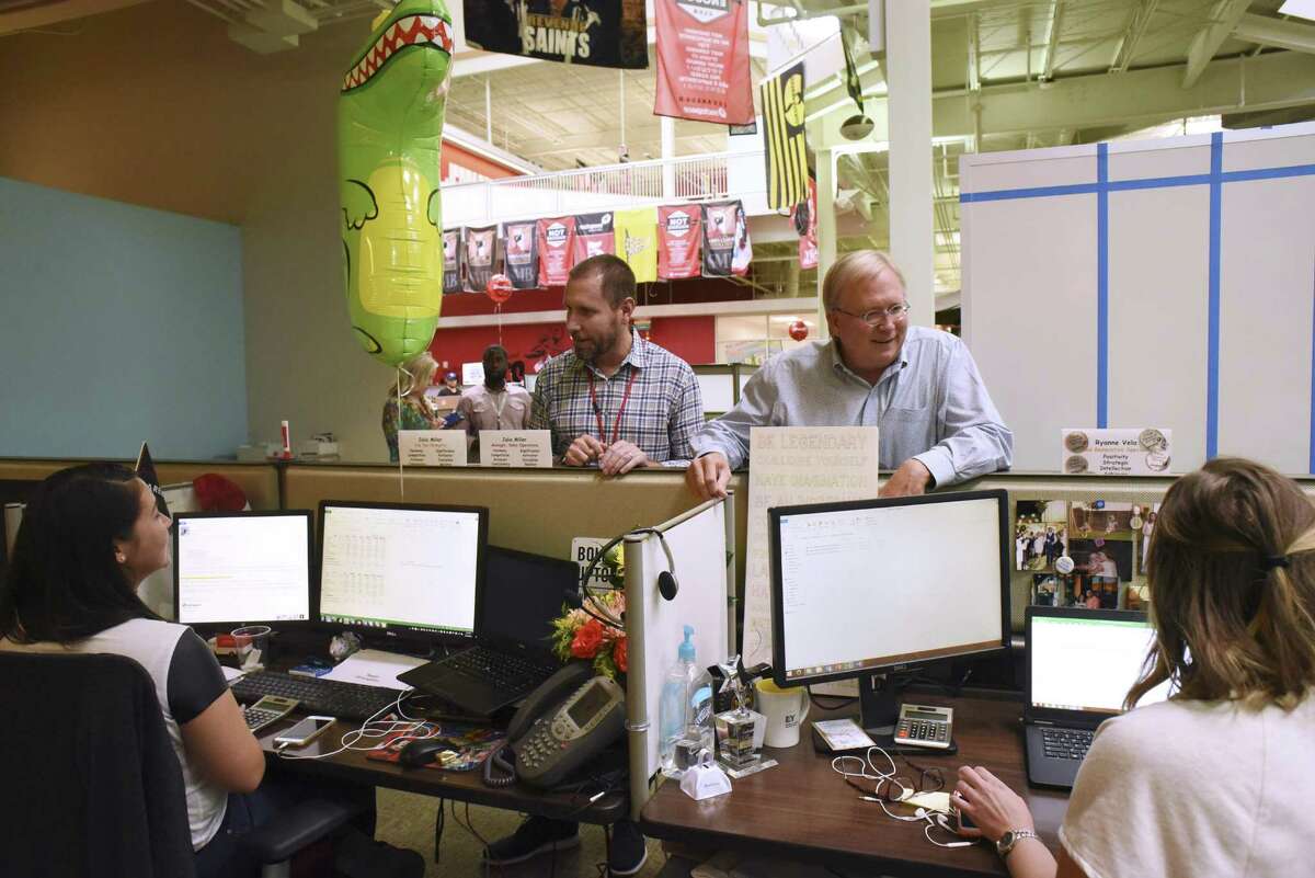 Rackspace CEO Taylor Rhodes, top left, and company co-founder Graham Weston, top right, speak with employees on Aug. 26, after the sale of the company to Apollo Global Management was announced. The company is cutting 6 percent of its U.S. workforce, more than 275 employees.