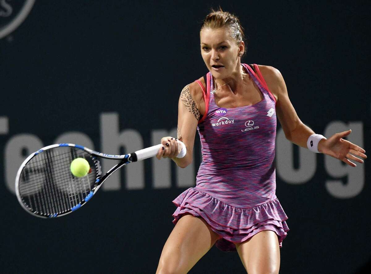 Agnieszka Radwanska, of Poland, hits a forehand against Petra Kvitova, of the Czech Republic, in a semifinal of the Connecticut Open tennis tournament Friday, Aug. 26, 2016 in New Haven, Conn. (Brad Horrigan/The Hartford Courant via AP)