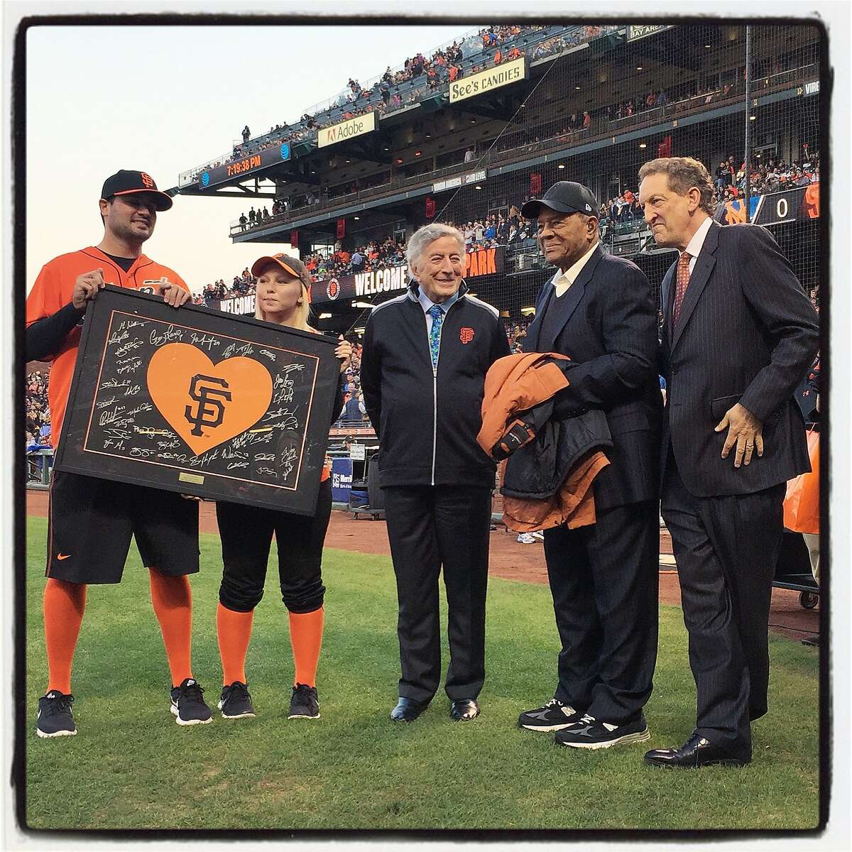 The SF Giants unveiled a new victory flag in honor of Tony Bennett (left) with Willie Mays and Giants CEO Larry Baer at AT&T Park. August 2016.