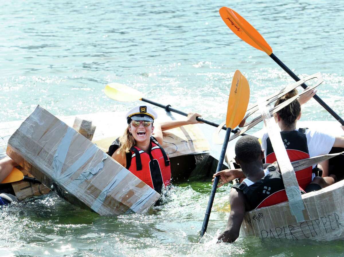 Kelly Aneson, of Edison, N.J., ended up in the water as her kayak SS Harambe sunk during the SoundWaters HarborFest 16 cardboard kayak race on Stamford Harbor Saturday.