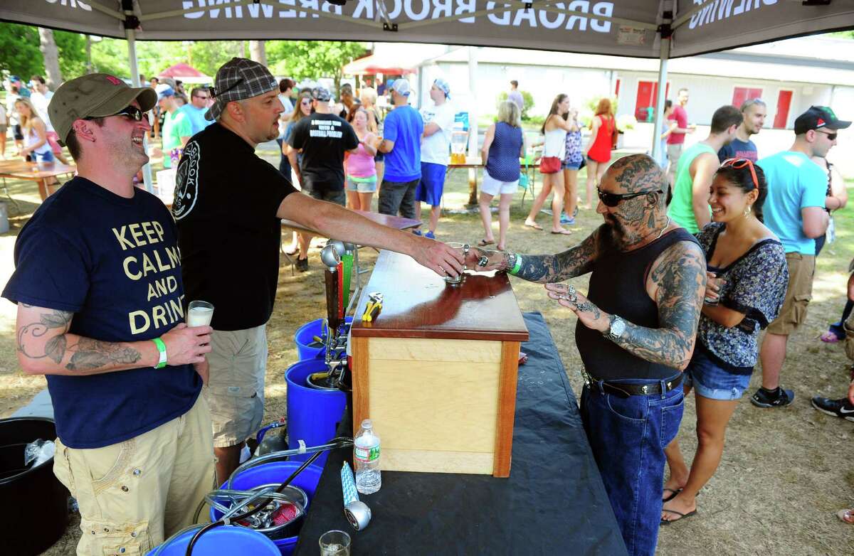 Nick "Batso" Maccharoli, of Stratford, at right, tries a brew from Broad Brook Brewing Company at the annual ShakesBeer Festival on the grounds of the American Shakespeare Festival Theater in Stratford, Conn. on Saturday August 27, 2016. The festival showcases fine craft beers from around Connecticut as well as nearby states. The event boasts a fantastic line up of both local and regional craft breweries (more than 60 in all); a diverse range of culinary options through several renowned CT Food Trucks and live bands playing classic covers. The event is also a fundraiser for the restoration of the American Shakespeare Theater.