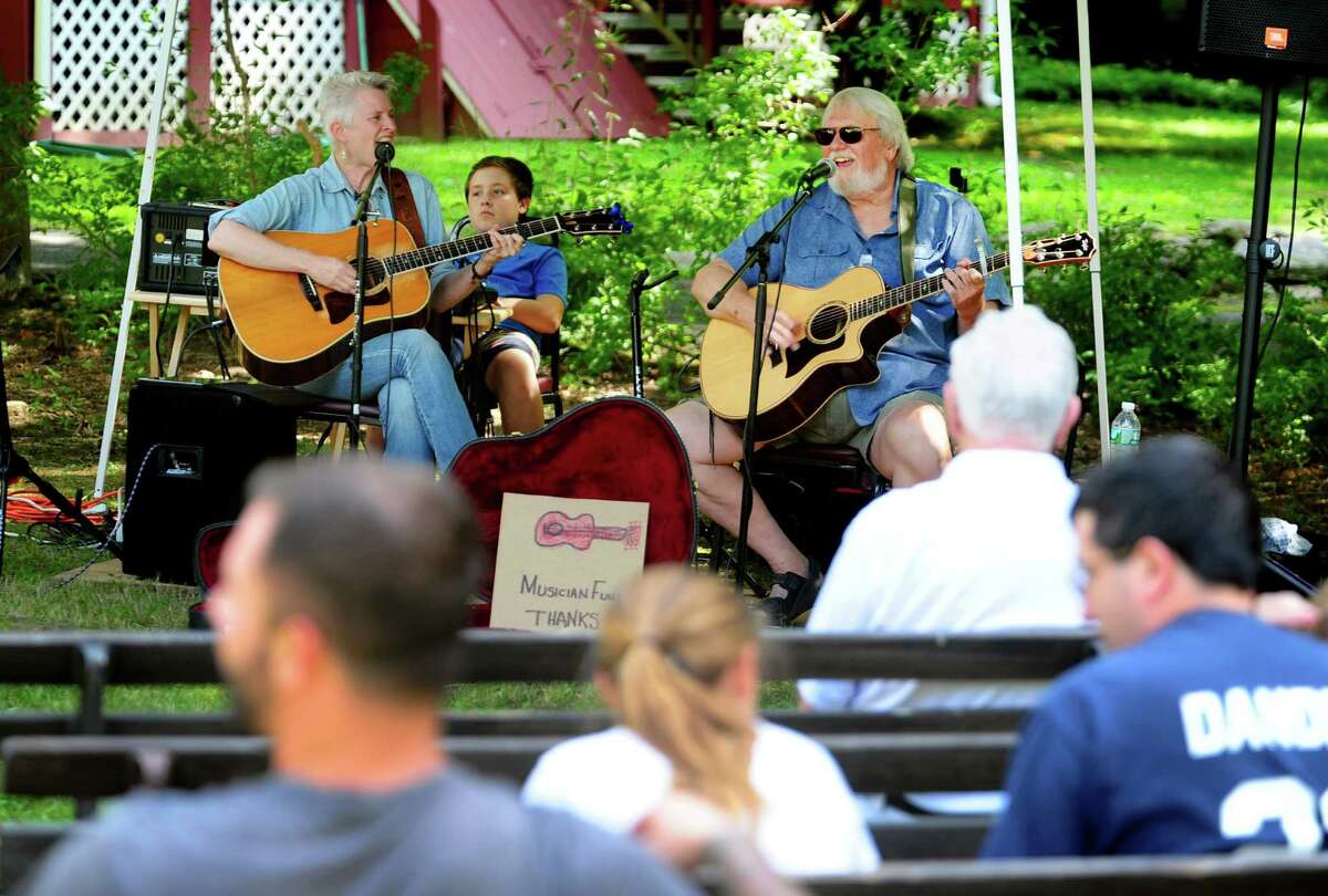 Musician Rob Carlson, right, performs with fellow musician Beth Bradley at the Greenfield Hill Grange Agricultural Fair on Hillside Road in Fairfield, Conn., on Saturday Aug. 27, 2016. There were farm and agricultural exhibits, grilled and baked goods, live poultry, games, a raffle, pony rides, live music, crafts and jewelry. Some of the exhibits and demonstrations included composting, square foot gardening, raising chickens and antique farm tools.