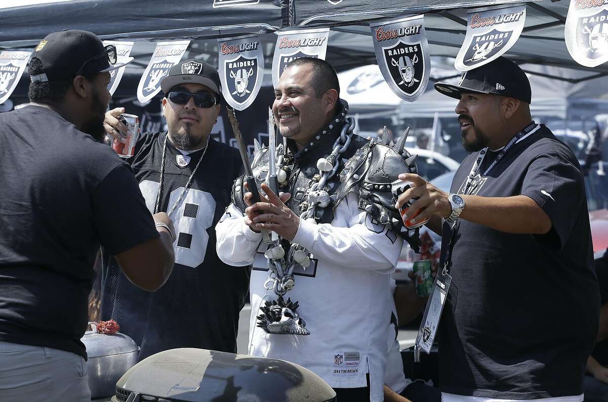 Fans tailgate outside the Oakland Coliseum before the start of an NFL preseason football game between the Oakland Raiders and the Tennessee Titans Saturday, Aug. 27, 2016, in Oakland, Calif. (AP Photo/Ben Margot)