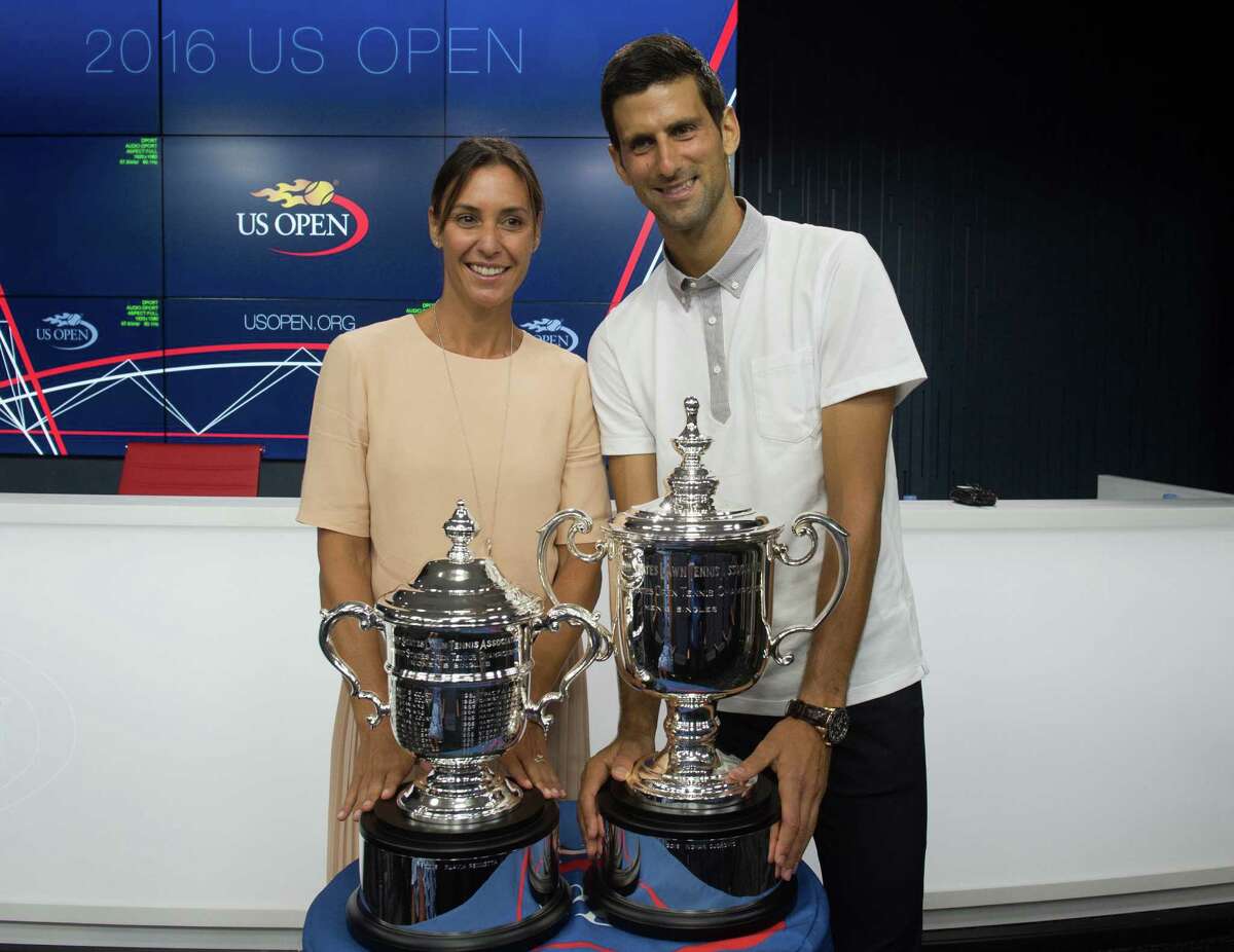 Reigning U.S. Open tennis champions Flavia Pennetta, left and Novak Djokovic, pose with their trophies during a media availability at the Billie Jean King National Tennis Center, Friday, Aug. 26, 2016, in New York. (AP Photo/Bryan R. Smith) ORG XMIT: NYBS101
