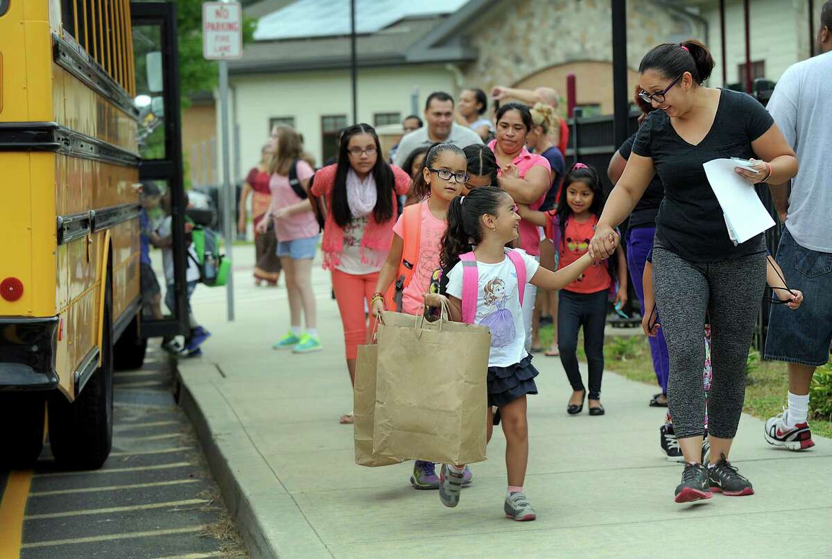 Emilia Ortega, 4, holds her mother Luisana's hand, as she arrives for the first day of school at Ellsworth Avenue Elementary in Danbury, Monday, August 29, 2016. Behind her is sister Camila, 8.