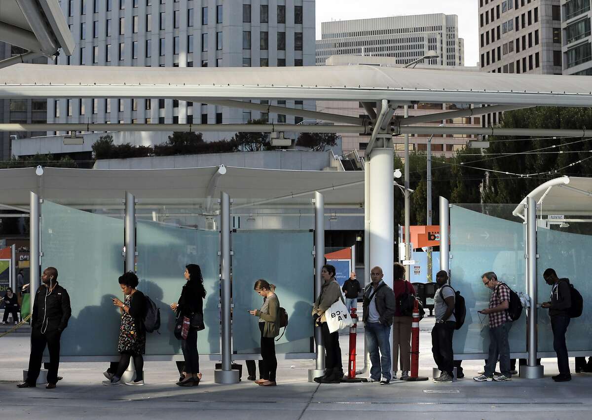 Passengers wait in line for a bus at the Temporary Transbay Terminal in San Francisco , Calif., on Monday, August 29, 2016.