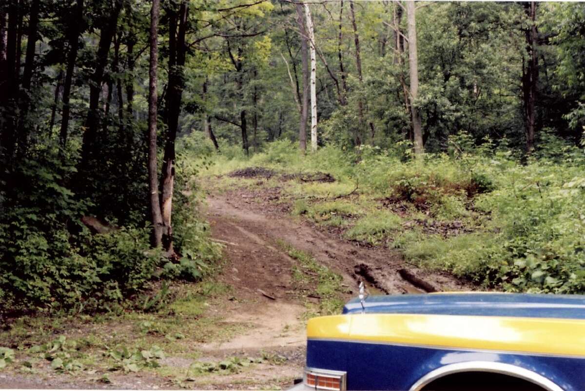 A state police cruiser parked at the scene where 15-year-old Robert "Bobby' Gutkaiss' decomposing body was found. State Police said they continue to investigate his 1983 homicide. (State Police)