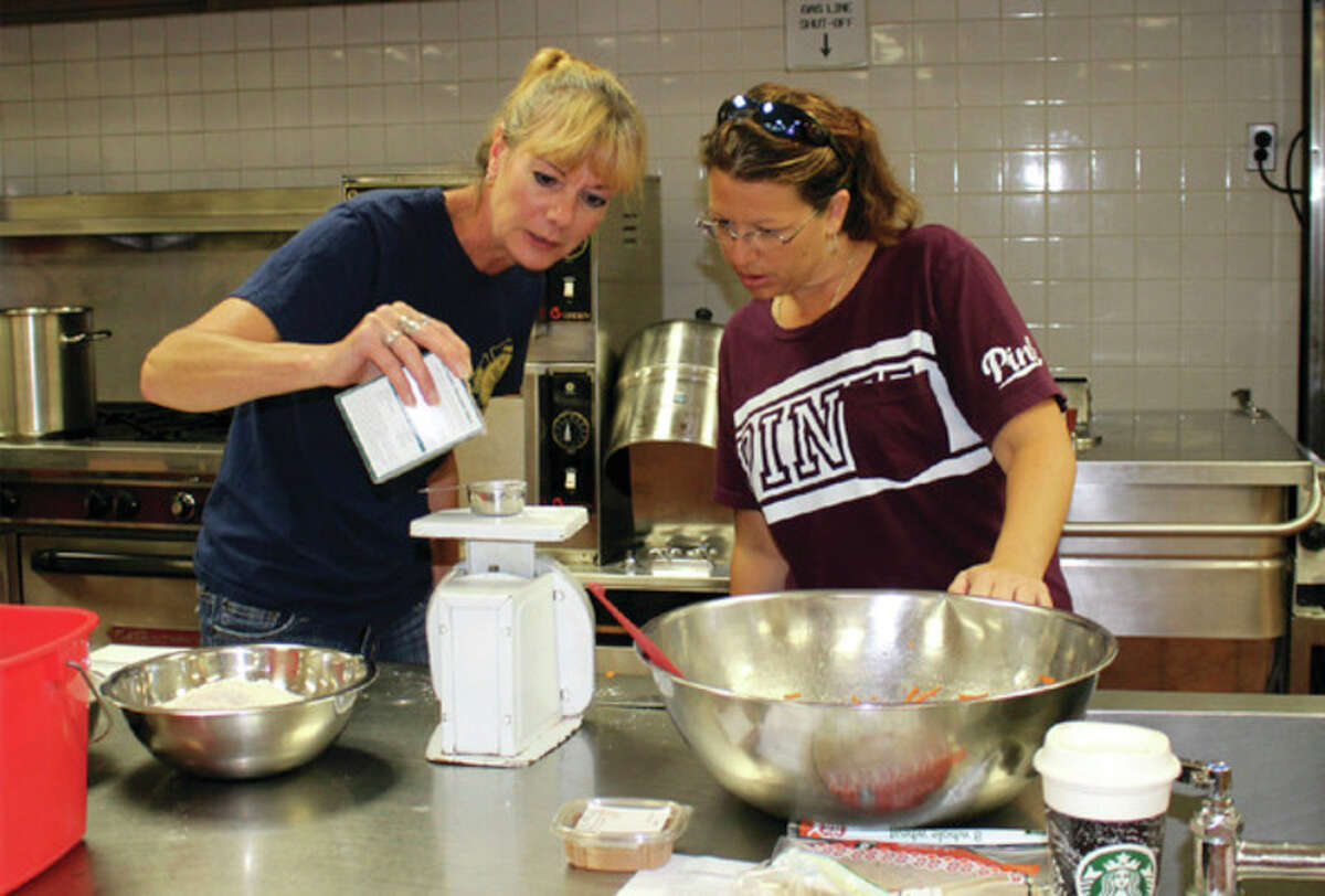 Laker food service employees Mary Pryor and Alicia Lovaas carefully measure ingredients for a recipe. Food service employees said they learned a lot during the training, and they can use what they've learned at school and at home. (Submitted Photo)