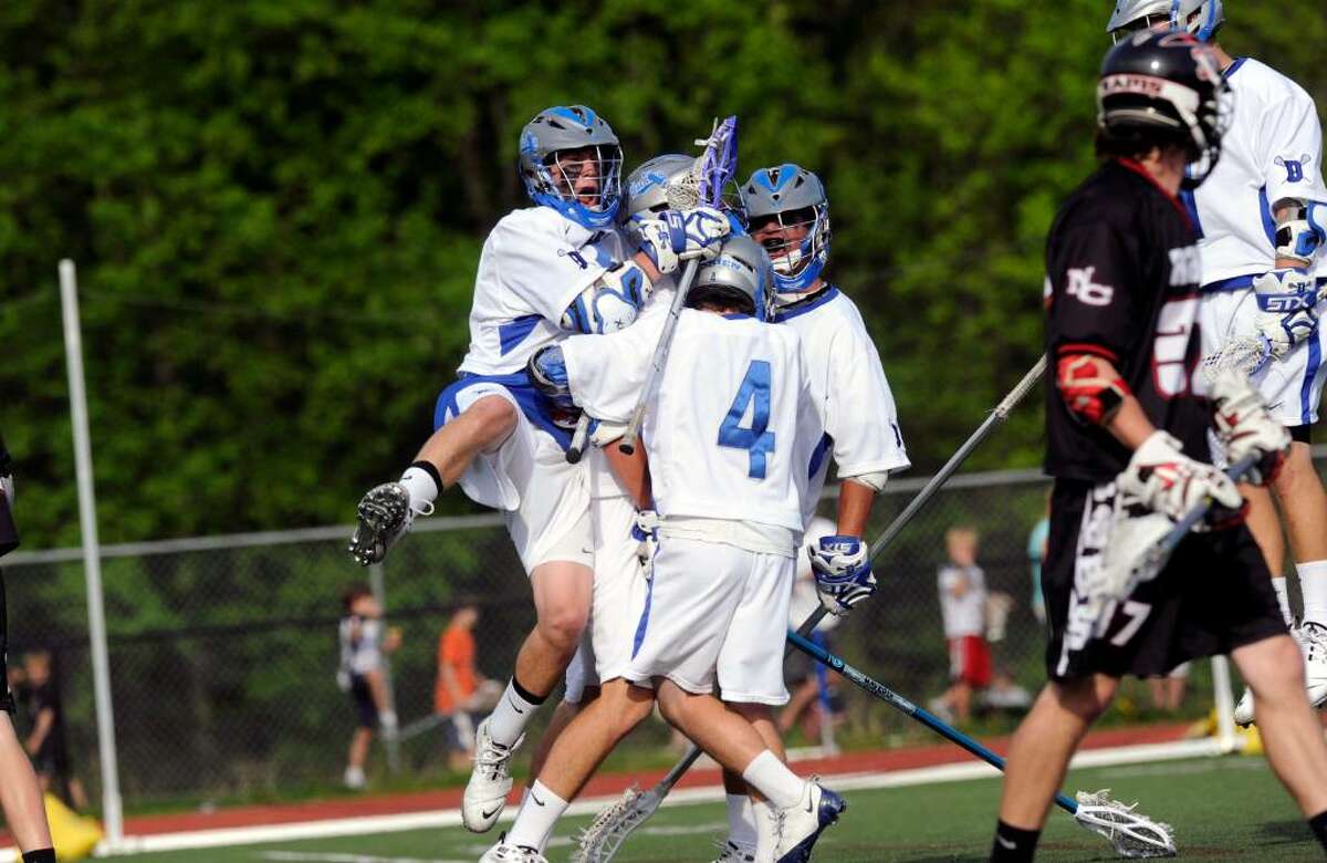 Darien boys lacrosse team reacts to one of many goals as Darien High School hosts New Canaan High in a boys lacrosse game Saturday, May 1, 2010. Darien won 11-5.