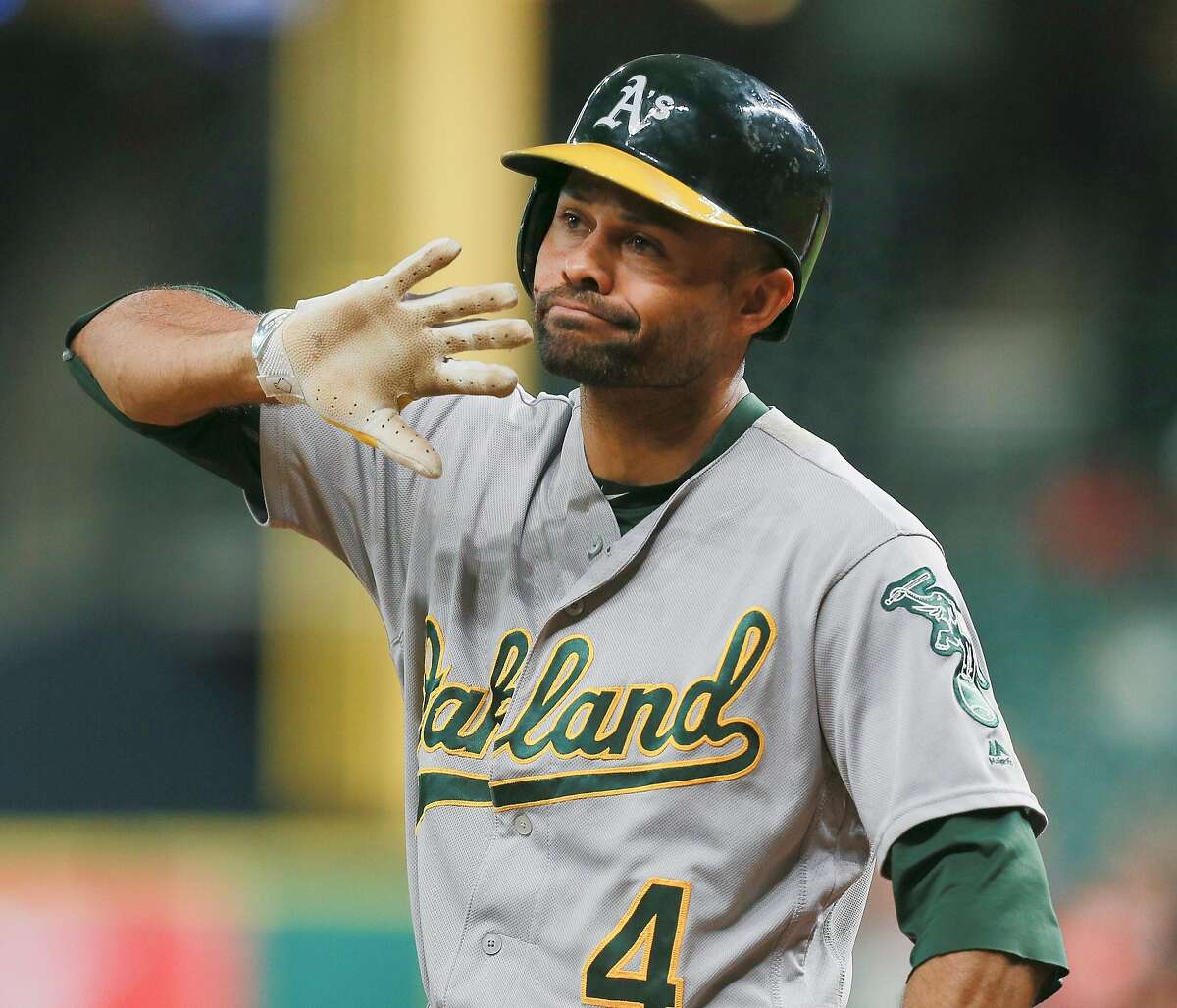 HOUSTON, TX - AUGUST 29: Coco Crisp #4 of the Oakland Athletics disagrees with the third base umpires decision that he didn't check his swing for strike three in the first inning against the Houston Astros at Minute Maid Park on August 29, 2016 in Houston, Texas. (Photo by Bob Levey/Getty Images)