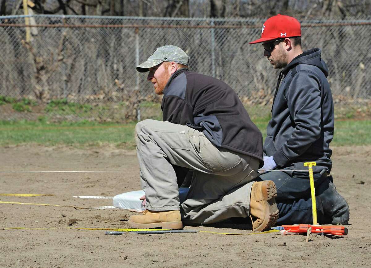 Keith Sweeney, stadium operations manager for the Tri-City ValleyCats, right, helps his General Manager Matt Callahan measure and install second base at the Upstate Premier Baseball field on Thursday, April 14, 2016 in Schenectady, N.Y. The Tri-City ValleyCats, with the support of BlueShield of Northeastern New York and Hannaford Supermarkets, renovated the Upstate Premier Baseball field on 4th Street & Campbell Avenue formerly known as Bellevue Little League. (Lori Van Buren / Times Union)