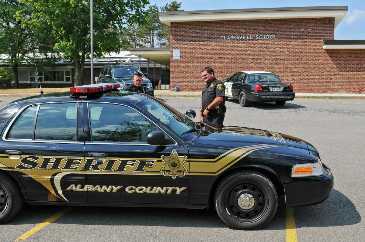 Albany County Sheriff's Office Deputy Chris Kopec, left, and Inspector Mark DeFrancesco, right, stand outside of the former Clarksville Elementary School, which will be housing the Albany Sheriff's Office public safety building, on Thursday July 12, 2012 in Clarksville, NY. The school was closed by the Bethlehem School District a year ago because of declining enrollment. (Philip Kamrass / Times Union)
