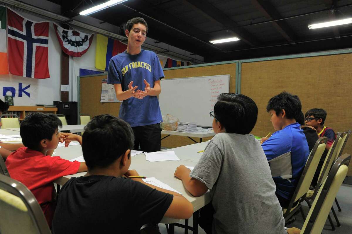 Austin Pager works with participants of an Academic Camp at Neighbors Link Stamford.