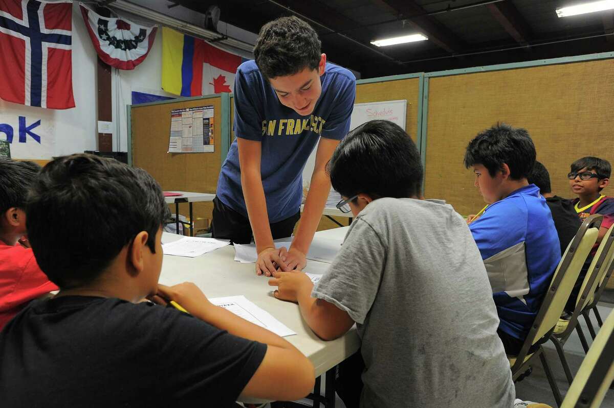 Austin Pager works with participants of an Academic Camp at Neighbors Link Stamford on Thursday, Aug, 25, 2016. Pager, a rising high school senior at Rye Country Day School in Rye, New York, volunteered a lot of time this summer engaging middle school students in math and science activities.