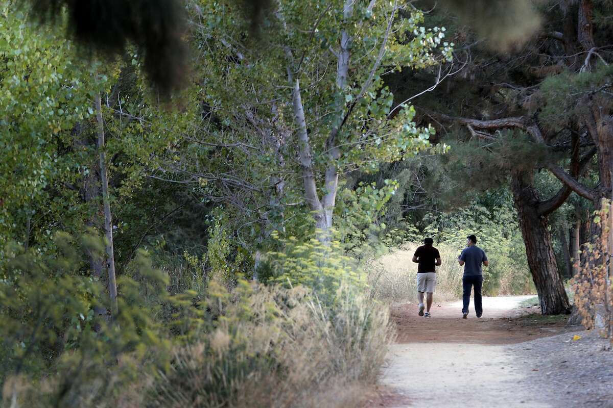 Two men (who declined to give their name) walk along the path at the Charleston Retention Basin next to the Google campus in Mountain View, Calif., on Tuesday, August 30, 2016. Google plans to pay to improve the basin, which is city owned property, despite concerns from some residents that the improvements might not be necessary.