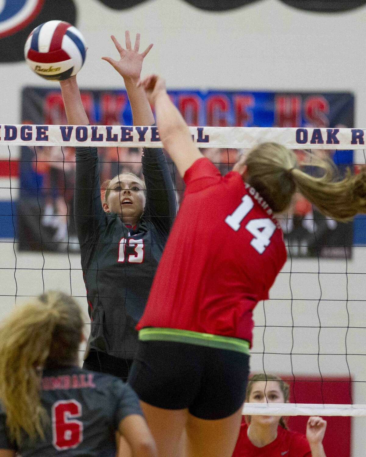 Oak Ridge middle outside hitter Brooke Clark (13) blocks a shot by Tomball right side hitter Kendall Glueck (14) during the first set of a non-district high school volleyball match Tuesday, Aug. 30, 2016, at Oak Ridge High School. Oak Ridge swept Tomball 3-0.