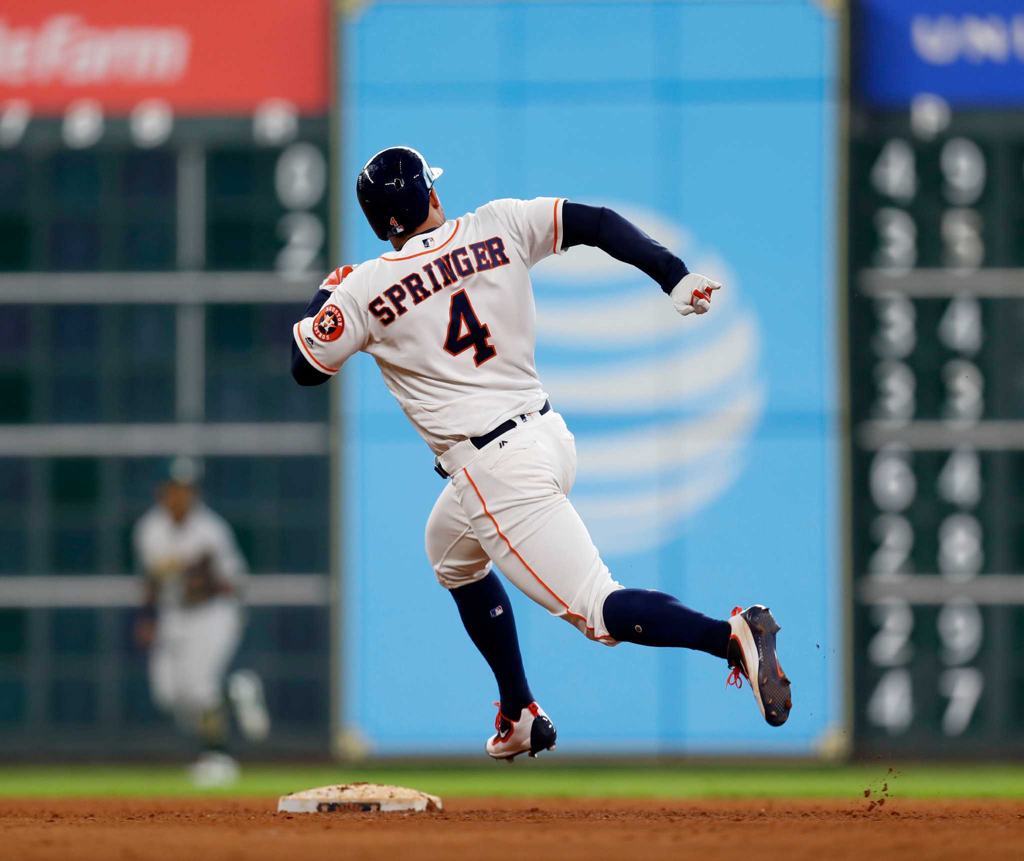 Houston Astros second baseman Jose Altuve (27) and shortstop Carlos Correa  laugh at the end of their 4-3 victory over the Oakland Athletics in a  baseball game, Wednesday, Aug. 31, 2016, in